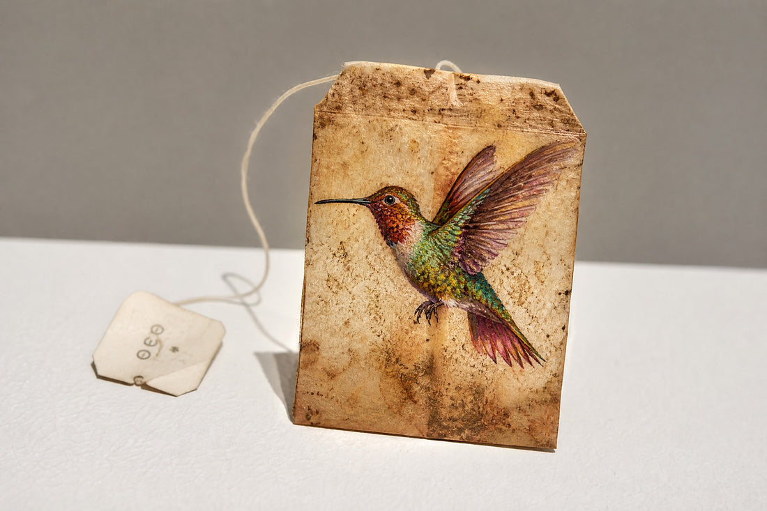Miniature hummingbird painting on an upcycled teabag